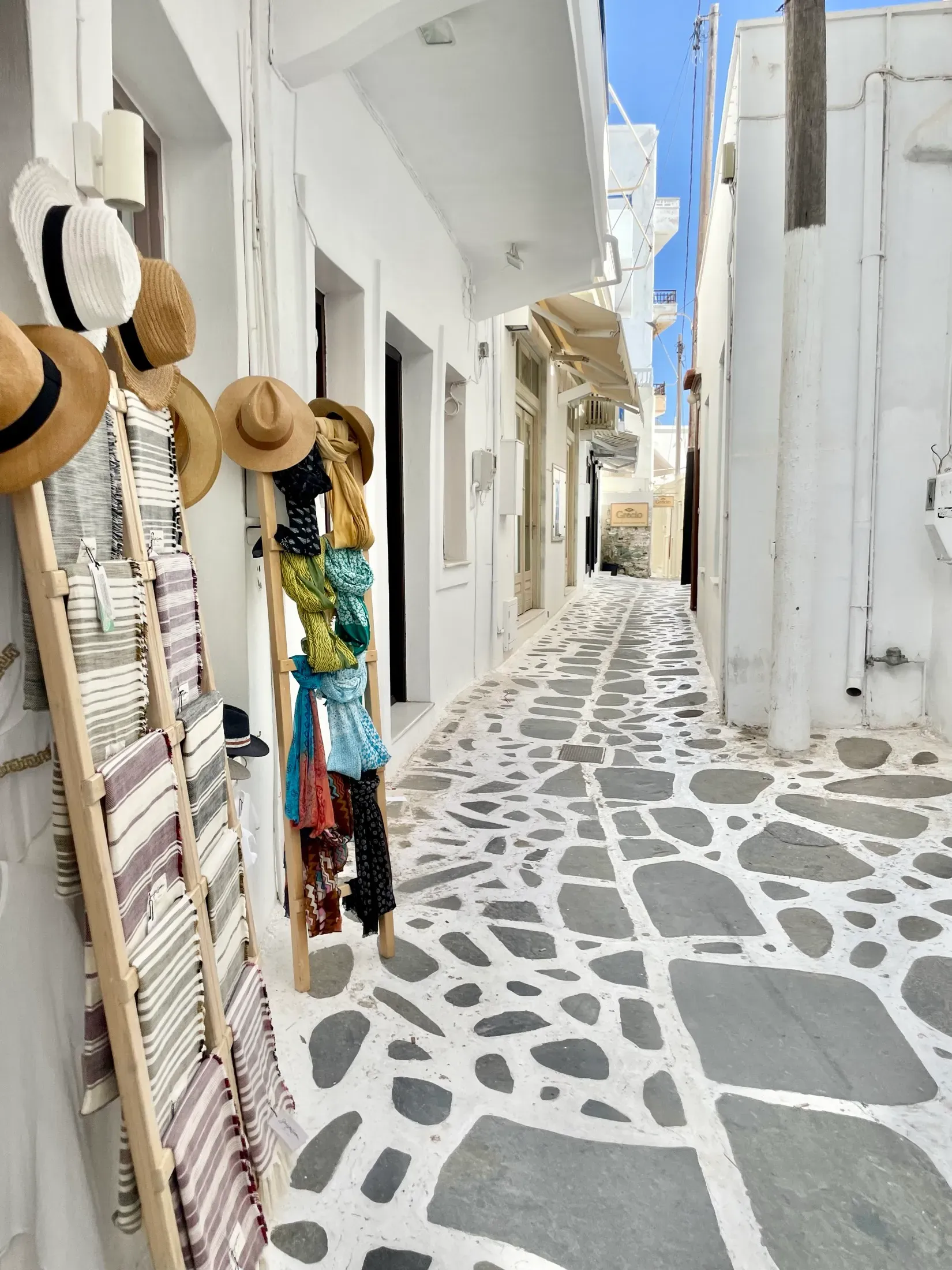A narrow whitewashed lane in a Cycladic village